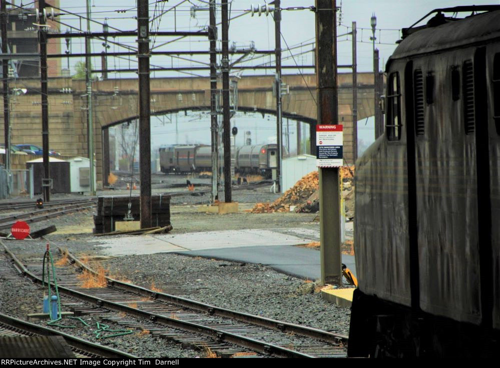 AMTK 90 heads west on train 43 as 4859 looks on.